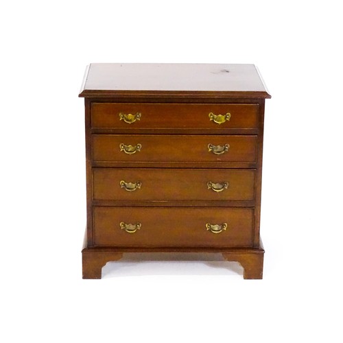 1683 - A mahogany chest of drawers of small proportions, having a moulded top above four long drawers with ... 