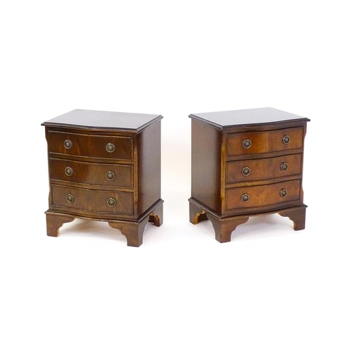 1686 - A pair of mahogany veneered bedside cabinets with serpentine shaped tops and each having three short... 