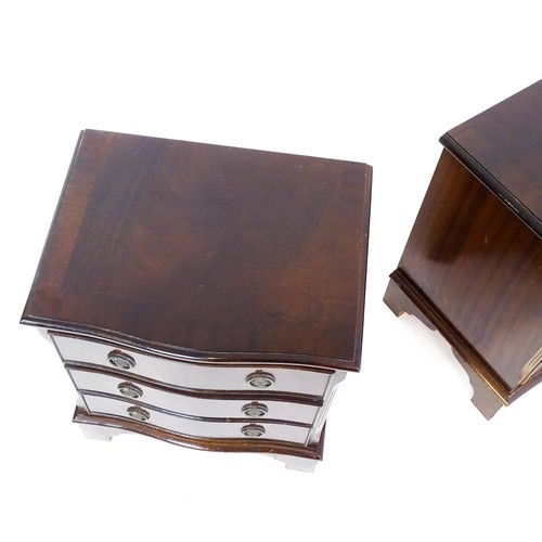 1686 - A pair of mahogany veneered bedside cabinets with serpentine shaped tops and each having three short... 