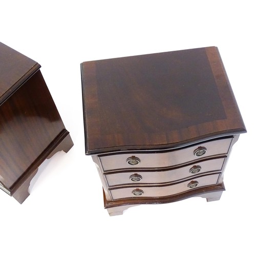 1686 - A pair of mahogany veneered bedside cabinets with serpentine shaped tops and each having three short... 