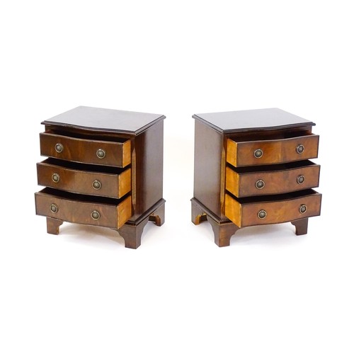 1686 - A pair of mahogany veneered bedside cabinets with serpentine shaped tops and each having three short... 