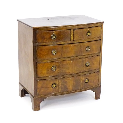 1686 - A pair of mahogany veneered bedside cabinets with serpentine shaped tops and each having three short... 