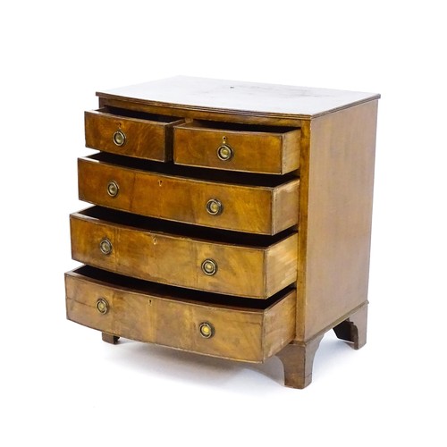 1686 - A pair of mahogany veneered bedside cabinets with serpentine shaped tops and each having three short... 