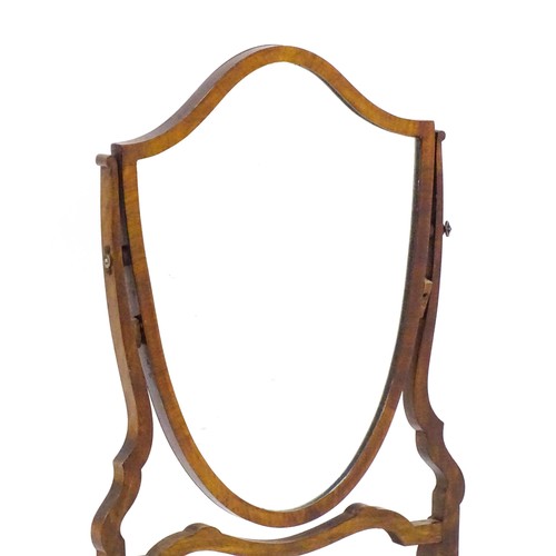 1687 - A late 19thC / early 20thC mahogany toilet mirror with a shield formed mirror on a shaped frame. 16