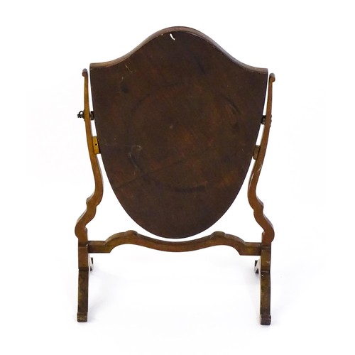 1687 - A late 19thC / early 20thC mahogany toilet mirror with a shield formed mirror on a shaped frame. 16