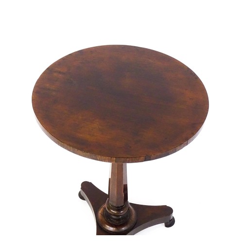 1688 - A mid 19thC rosewood occasional table, with a circular top above a canted pedestal and triform base ... 