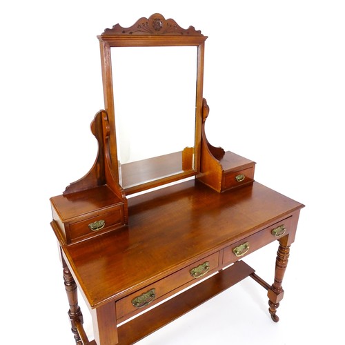 1689 - An Aesthetic movement mahogany dressing table with carved floral detailing, two short drawers above ... 