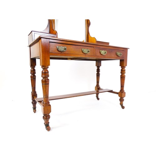 1689 - An Aesthetic movement mahogany dressing table with carved floral detailing, two short drawers above ... 