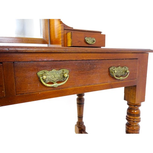 1689 - An Aesthetic movement mahogany dressing table with carved floral detailing, two short drawers above ... 