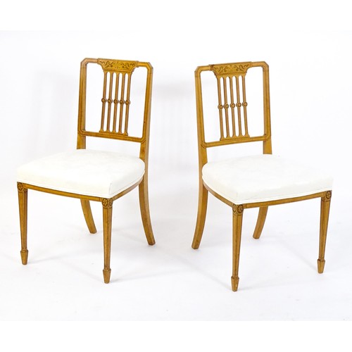 1690 - A pair of late 19thC / early 20thC satinwood side chairs, with marquetry and penwork decoration,  ba... 