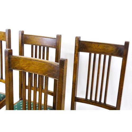 1691 - A set of six early / mid 20thC oak dining chairs, with slatted back splats, drop in seats and raised... 