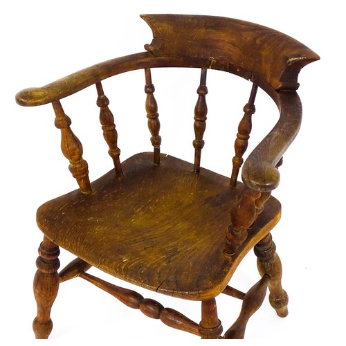 1693 - A late 19thC / early 20thC smokers bow chair, with a bowed backrest, turned tapering supports and a ... 