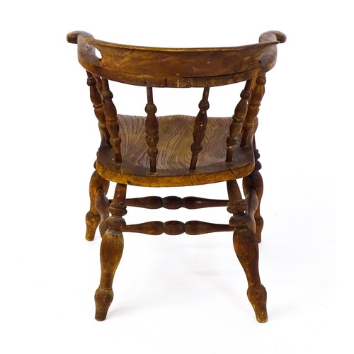 1693 - A late 19thC / early 20thC smokers bow chair, with a bowed backrest, turned tapering supports and a ... 