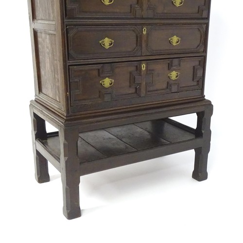 1694 - A late 17thC / early 18thC oak chest on stand, having  rectangular moulded top above an applied carv... 