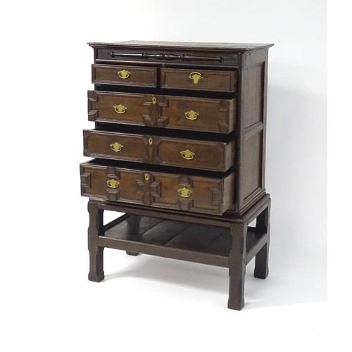 1694 - A late 17thC / early 18thC oak chest on stand, having  rectangular moulded top above an applied carv... 