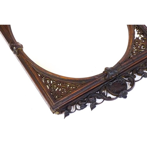 1699 - A 19thC carved rosewood mirror, with floral mouldings and a fretwork carved surround. 22