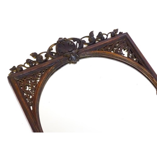 1699 - A 19thC carved rosewood mirror, with floral mouldings and a fretwork carved surround. 22