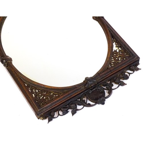 1699 - A 19thC carved rosewood mirror, with floral mouldings and a fretwork carved surround. 22