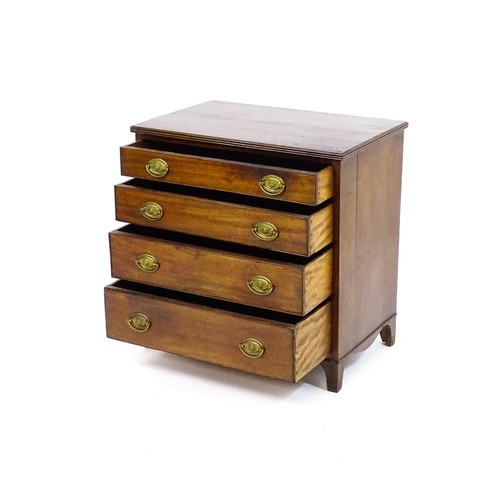 1702 - A late Georgian mahogany chest of drawers with a reeded top above four long graduated drawers with b... 