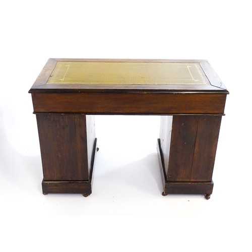 1703 - A late 19thC / early 20thC double pedestal desk with an inset leather top and two banks of four shor... 