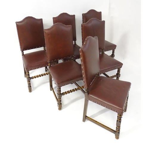 1705 - A set of six oak dining chairs with studded upholstery and block and turned legs with barley twist s... 