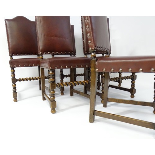 1705 - A set of six oak dining chairs with studded upholstery and block and turned legs with barley twist s... 