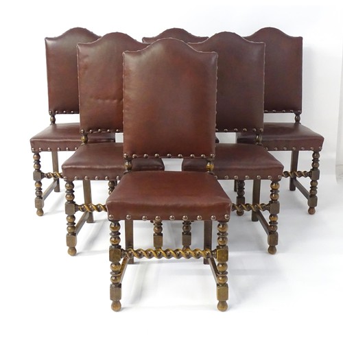 1705 - A set of six oak dining chairs with studded upholstery and block and turned legs with barley twist s... 