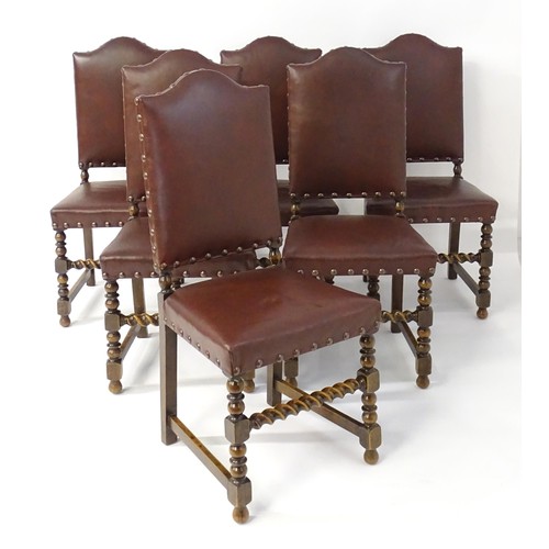 1705 - A set of six oak dining chairs with studded upholstery and block and turned legs with barley twist s... 