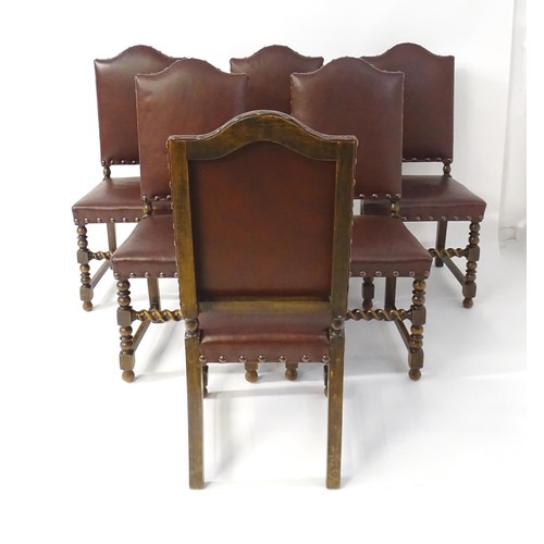 1705 - A set of six oak dining chairs with studded upholstery and block and turned legs with barley twist s... 