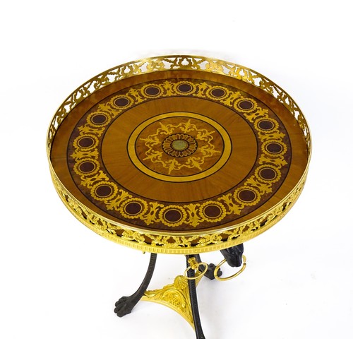 1706 - A tripod table with a marquetry inlaid top with a pierced gilt rim,, the base of cast metal construc... 