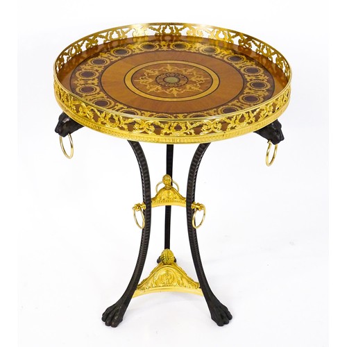 1706 - A tripod table with a marquetry inlaid top with a pierced gilt rim,, the base of cast metal construc... 