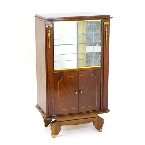 1708 - A mid 20thC continental cabinet with a palissandre veneered frame, brass mounts, internal mirrors an... 