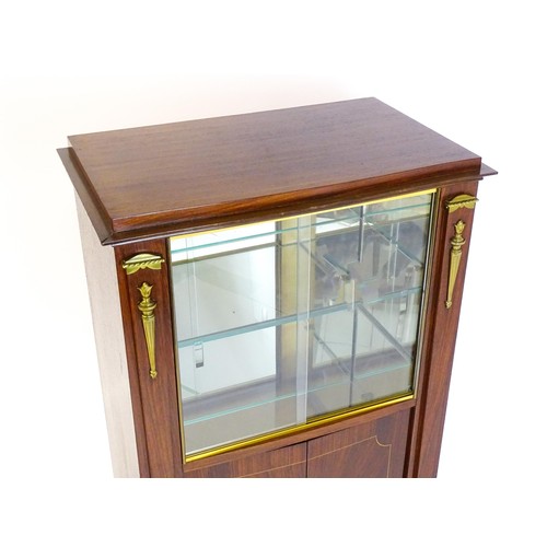 1708 - A mid 20thC continental cabinet with a palissandre veneered frame, brass mounts, internal mirrors an... 