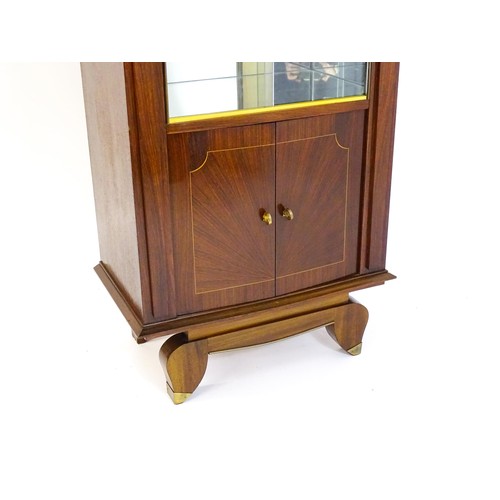 1708 - A mid 20thC continental cabinet with a palissandre veneered frame, brass mounts, internal mirrors an... 