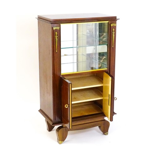 1708 - A mid 20thC continental cabinet with a palissandre veneered frame, brass mounts, internal mirrors an... 