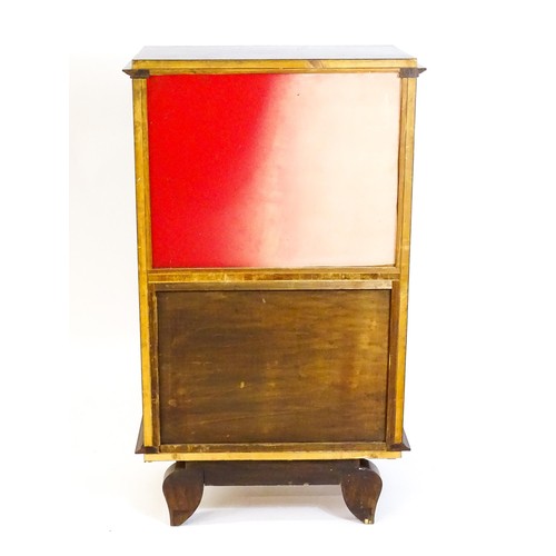 1708 - A mid 20thC continental cabinet with a palissandre veneered frame, brass mounts, internal mirrors an... 