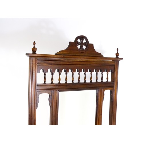 1709 - An Aesthetic style hall stand of mahogany construction, surmounted by turned finials and floral carv... 