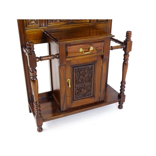 1709 - An Aesthetic style hall stand of mahogany construction, surmounted by turned finials and floral carv... 