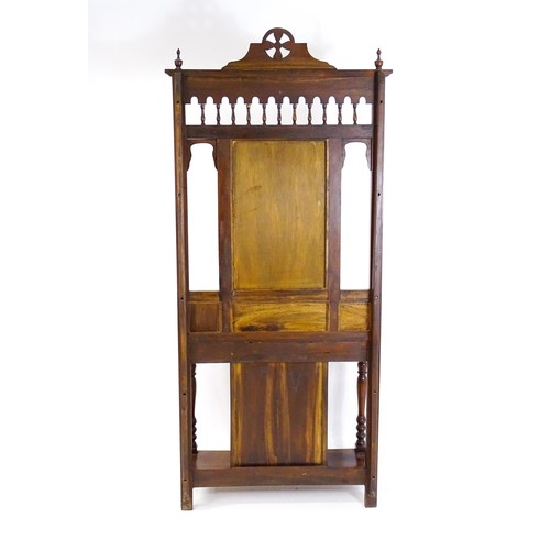 1709 - An Aesthetic style hall stand of mahogany construction, surmounted by turned finials and floral carv... 