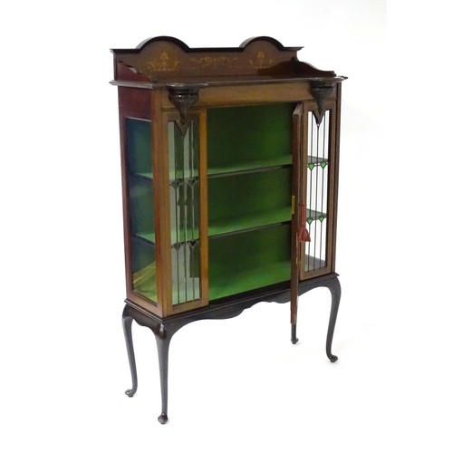 1711 - An Edwardian mahogany display cabinet with leaded glass panelling, stained glass panels and a satinw... 