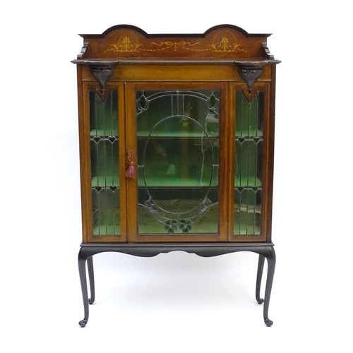 1711 - An Edwardian mahogany display cabinet with leaded glass panelling, stained glass panels and a satinw... 