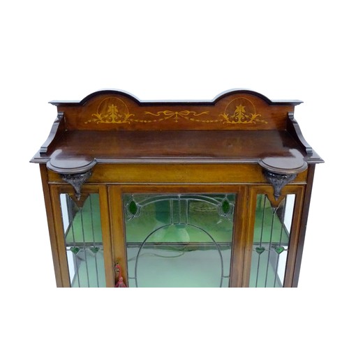 1711 - An Edwardian mahogany display cabinet with leaded glass panelling, stained glass panels and a satinw... 