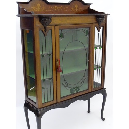 1711 - An Edwardian mahogany display cabinet with leaded glass panelling, stained glass panels and a satinw... 