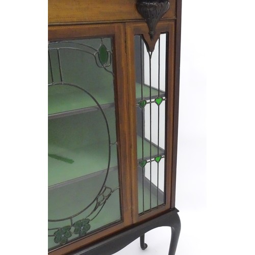 1711 - An Edwardian mahogany display cabinet with leaded glass panelling, stained glass panels and a satinw... 