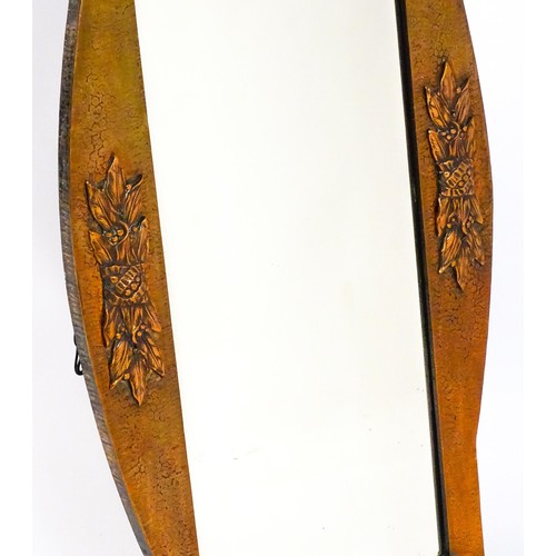 1713 - An Arts & Crafts style hammered coppered mirror with rivet detailing and a bevelled glass. 19