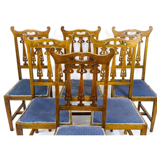 1720 - A set of six oak Arts & Crafts dining chairs with shaped, pierced top rails and floral back splats r... 