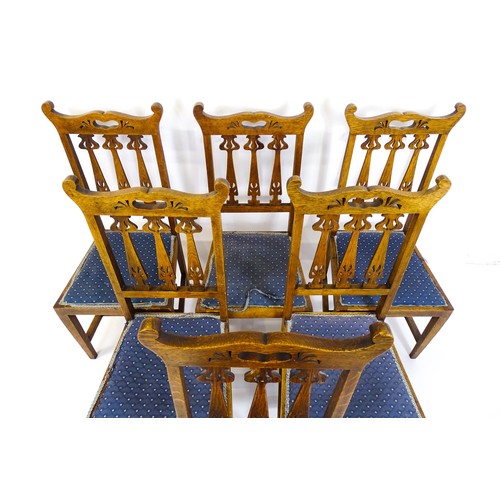 1720 - A set of six oak Arts & Crafts dining chairs with shaped, pierced top rails and floral back splats r... 