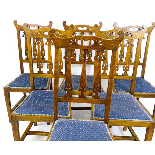 1720 - A set of six oak Arts & Crafts dining chairs with shaped, pierced top rails and floral back splats r... 