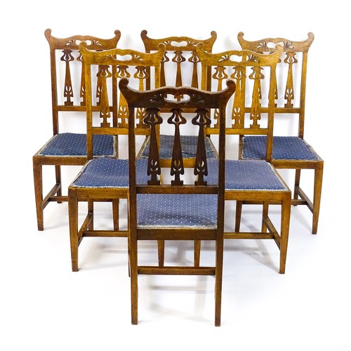 1720 - A set of six oak Arts & Crafts dining chairs with shaped, pierced top rails and floral back splats r... 