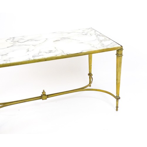 1721 - A late 19thC / early 20thC marble topped coffee table with a brass base and four tapering legs unite... 